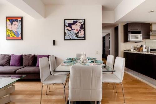 a dining room and living room with a table and chairs at Beautiful apartment in Polanco area with amenities in Mexico City