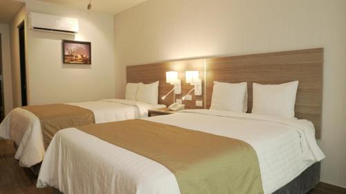 Cama o camas de una habitación en Hotel Nuvo