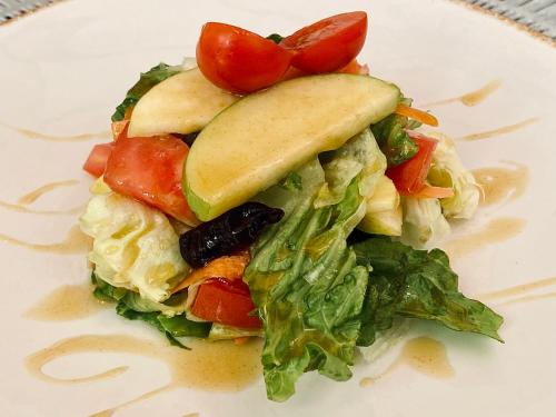 a white plate with a sandwich with lettuce and tomatoes at Hotel Senorial in Querétaro