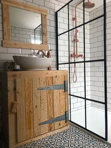 a bathroom with a sink and a mirror at The Wynd Cottage in Amble