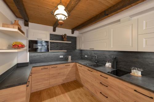 a kitchen with wooden cabinets and a ceiling at U Komárků in Špindlerův Mlýn