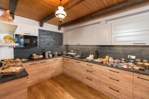 a kitchen with wooden cabinets and a counter top at U Komárků in Špindlerův Mlýn