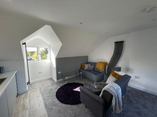 a living room with a couch and a chair at BH - Luxurious 1 bed top floor apartment with parking - please read about score in Shottery
