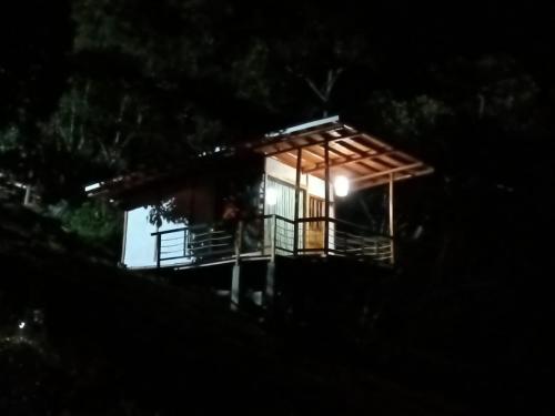 a small house at night with a light on it at El Refugio del Oso de Anteojos in Fómeque