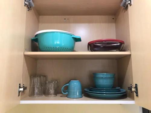 a cupboard filled with blue bowls and plates at Hotel Phillips in Bartlesville