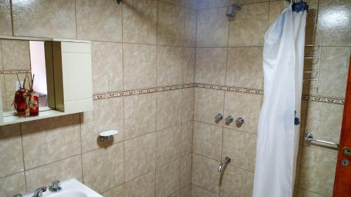 a bathroom with a shower and a sink at Perlas del Mar in Puerto Madryn