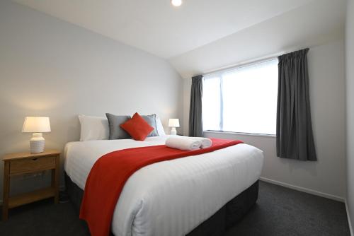 a bedroom with a large bed with a large window at Riccarton Mall Motel in Christchurch