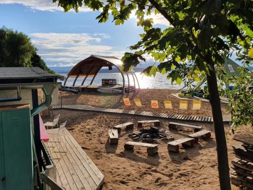 a picnic table on the beach next to the water at Relax Vila Lipno 1 u pláže Windy Point in Černá v Pošumaví