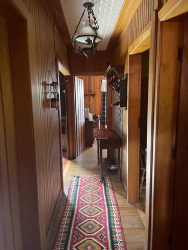 a hallway of a house with a rug on the floor at Cabana Austríaca no Vale Encantado in Campos do Jordão