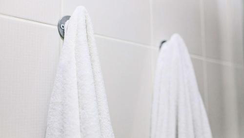 a white towel hanging on a wall in a bathroom at Castaways Resort and Suites in Freeport