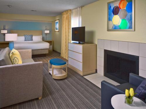 a hotel room with a bed and a fireplace at Sonesta ES Suites Minneapolis-St. Paul Airport in Eagan