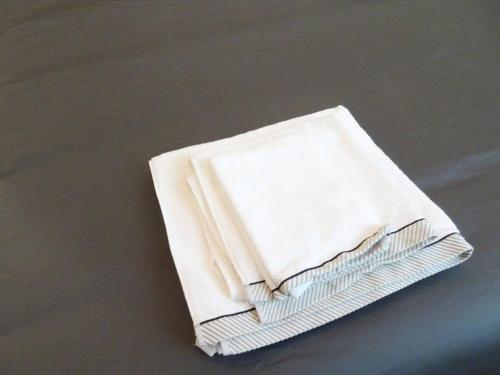 a stack of white napkins sitting on a table at SMART Rooms Pistoia in Pistoia