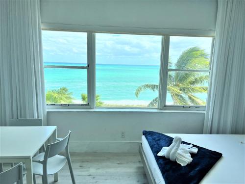 a bedroom with a view of the ocean from a window at Ocean Front Units at Miami Beach in Miami Beach