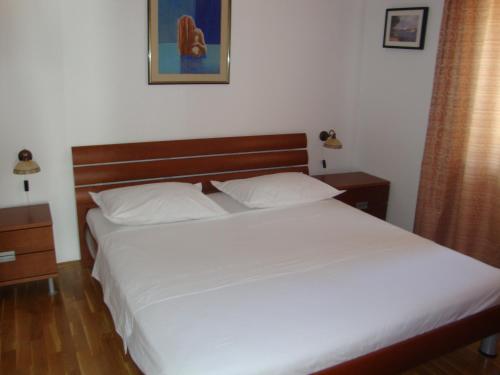 Postel nebo postele na pokoji v ubytování Longo Apartment