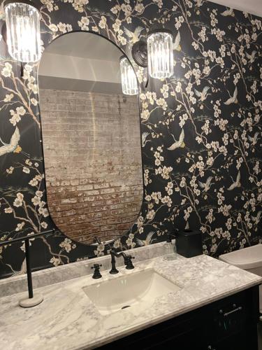 a bathroom with a sink and a mirror at Luxury City Escape & Peaceful Retreat by Hollyhock in Louisville
