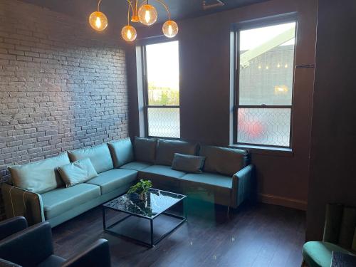 a living room with a couch and a table at Luxury City Escape & Peaceful Retreat by Hollyhock in Louisville