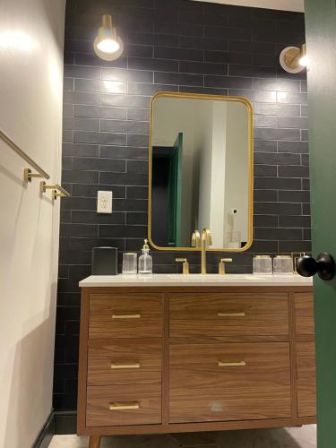 a bathroom with a sink and a mirror at Luxury City Escape & Peaceful Retreat by Hollyhock in Louisville