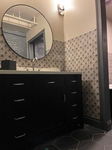 a bathroom with a sink and a mirror at Luxury City Escape & Peaceful Retreat by Hollyhock in Louisville