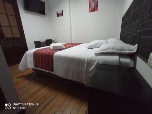 a bedroom with a bed with two pillows on it at Catedral in Arequipa