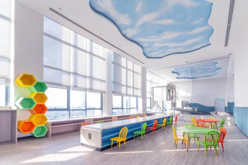 a cafeteria with colorful chairs and a table at M World Hotel in Petaling Jaya