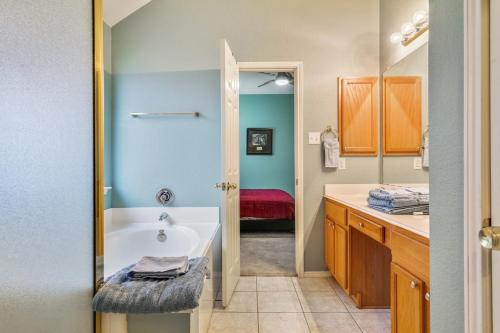 a bathroom with a tub and a sink at Centrally located 3-Bedroom and 2-Bath The Colony Home with Great North Dallas Access home in The Colony