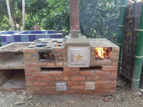 an outdoor brick oven with a fire in it at FINCA CAMPESTRE EL MIRADOR VIOTA in Viotá