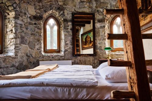 a bedroom with a bed in a stone wall at Burg Plankenstein in Texing