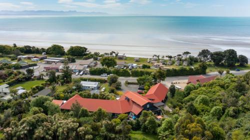 an aerial view of a resort with the ocean in the background at Ratanui Lodge in Pohara