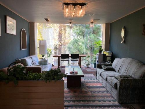 a living room with a couch and a table at Petit Hotel Yukikkoso in Yuzawa