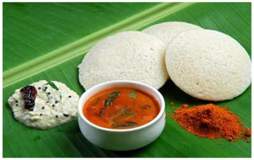 a plate of food with a bowl of soup on a banana leaf at Hotel White Fields Hitec City, Hyderabad in Hyderabad