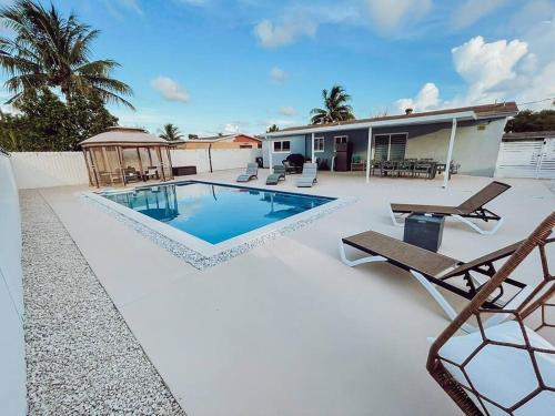a swimming pool on a patio with a house at MIAMI PARADISE in Miami