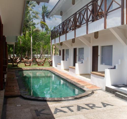 a swimming pool in the courtyard of a house at Katara Gili, Boutique Rooms and Bungalows in Gili Trawangan