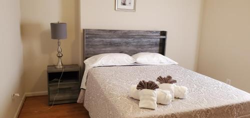 a bedroom with a bed with two pairs of slippers at RELAXING 3 BR WITH FREE PARKING AT THE SEQUOIA in Washington