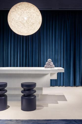 a stage with a table with a blue curtain at TAOXICHUAN Hotel in Jingdezhen