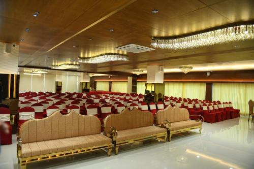 a large banquet hall with chairs and tables in it at Hotel Blueivy Anand in Anand