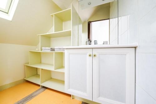 a bathroom with a white cabinet and a mirror at Le Berry - Maison de ville - Parking privé in Bourges