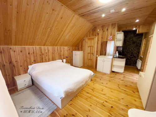 a bedroom with a bed in a wooden room at Shtil in Kyiv