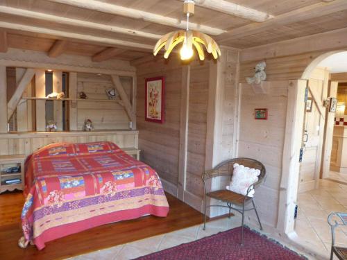 a bedroom with a bed and a chair in a room at Appartement La Clusaz, 5 pièces, 8 personnes - FR-1-304-40 in La Clusaz