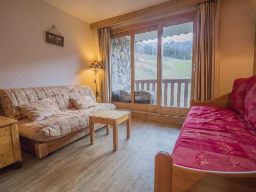 a living room with a couch and a balcony at Appartement Valmorel, 2 pièces, 4 personnes - FR-1-356-292 in Valmorel