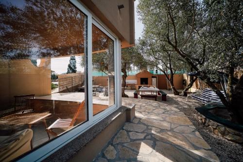 a view of a patio from the window of a house at Villa Frida in Sutomišćica