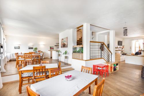 a dining room with wooden tables and chairs at Penzion Quest in Loket