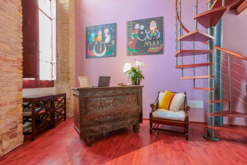 a living room with a wooden dresser and a staircase at Sa Domu Cheta in Cagliari