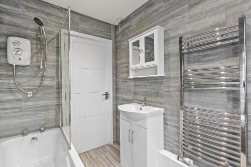 a bathroom with a shower and a toilet and a sink at Entire beautiful home in the heart of Huntingdon, Bury in Bury