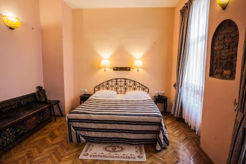 a bedroom with a bed with a black and white blanket at Casa Wagner in Braşov