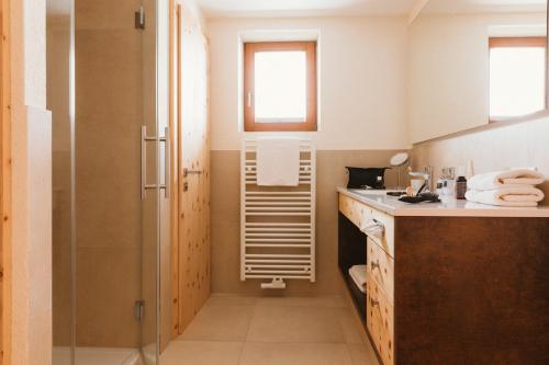 a bathroom with a shower and a sink at Gartenhotel Linde 4 Sterne Superior in Ried im Oberinntal