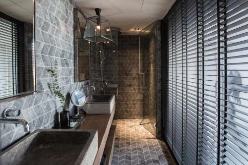a bathroom with a sink and a mirror at Clay Beach Samui - Beachfront Villas in Amphoe Koh Samui