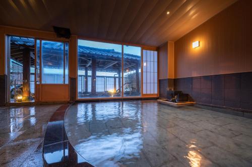 a room with a glass table in the middle of a building at Ikkyu -Seaside Hotel- in Tsuruoka