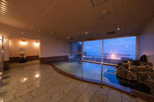 a large room with a view of the ocean at Ikkyu -Seaside Hotel- in Tsuruoka