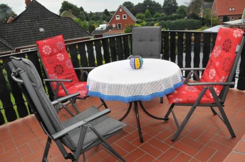 two chairs and a table on a balcony at Ferienwohnung Bruns 15028 in Leer