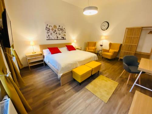 a bedroom with a bed with red pillows at Unesco Prague Apartments in Prague